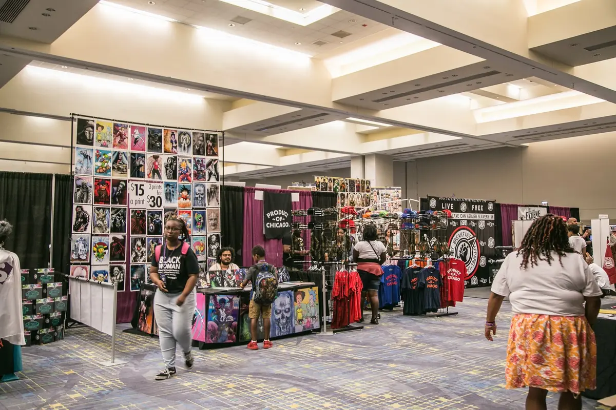 A wide view of the vendor hall, booths along both sides of the aisle.